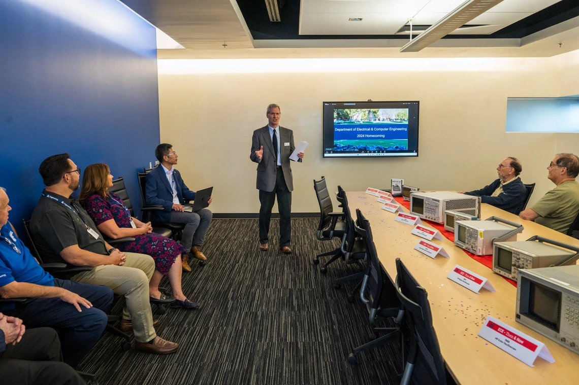 people seated at conference room table